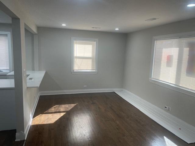 empty room with recessed lighting, baseboards, and wood finished floors