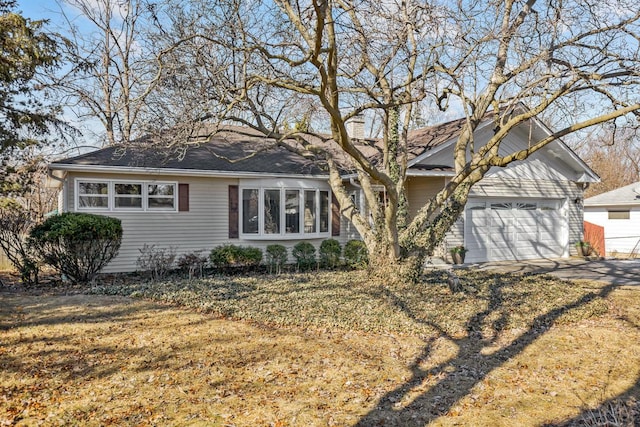 single story home featuring a garage and concrete driveway