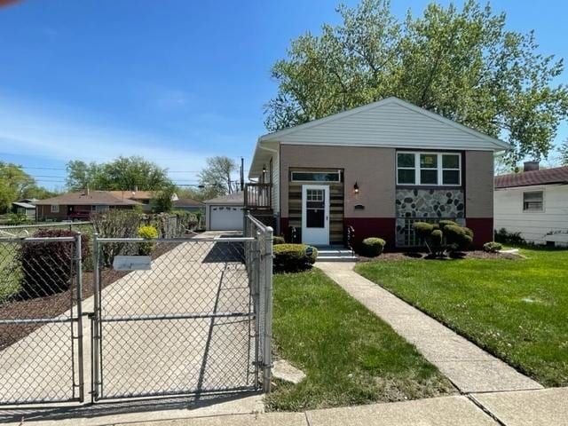 bungalow with an outbuilding, a front lawn, fence, and a gate