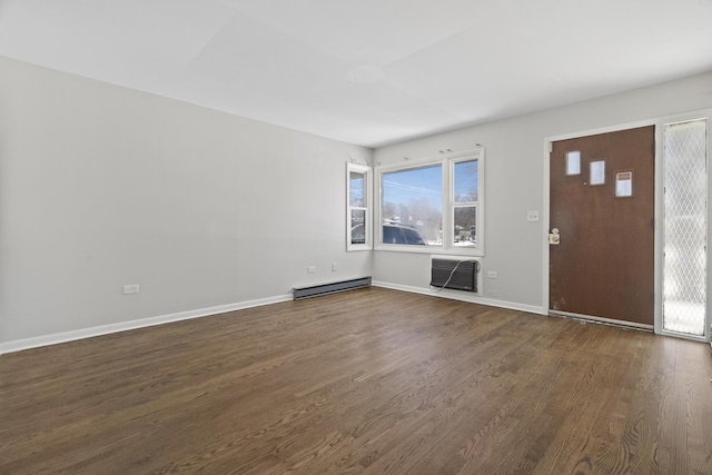 entrance foyer featuring an AC wall unit, baseboard heating, dark wood finished floors, and baseboards