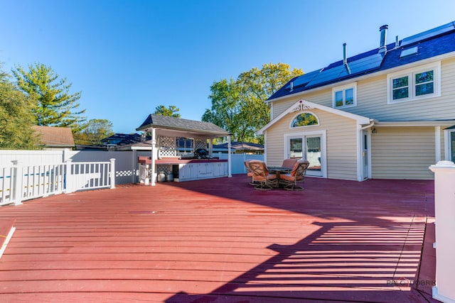 wooden terrace with outdoor dining space and fence