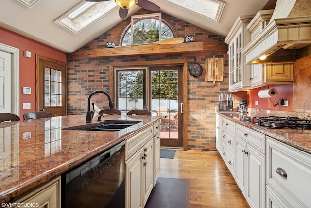 kitchen with black dishwasher, a healthy amount of sunlight, a sink, and custom exhaust hood