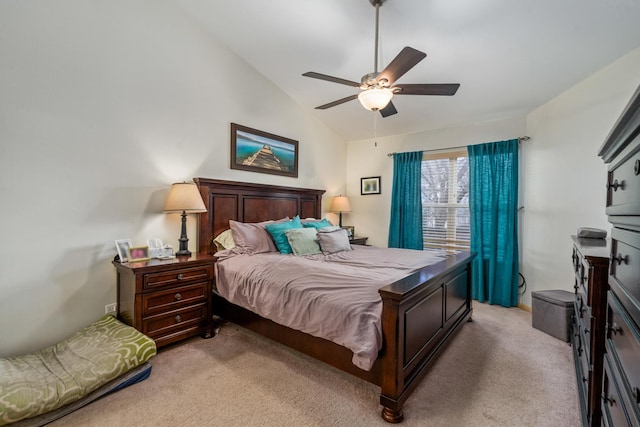 bedroom featuring light carpet, lofted ceiling, and a ceiling fan