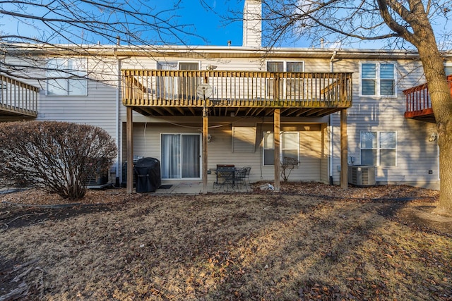 rear view of house with a patio, a chimney, and central air condition unit