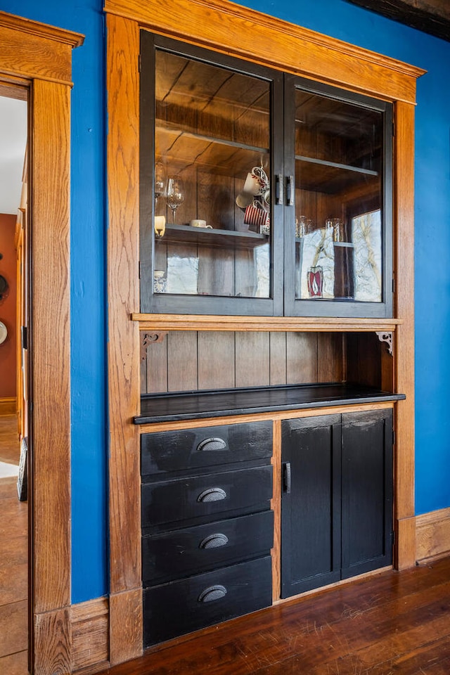 interior details featuring baseboards and wood finished floors