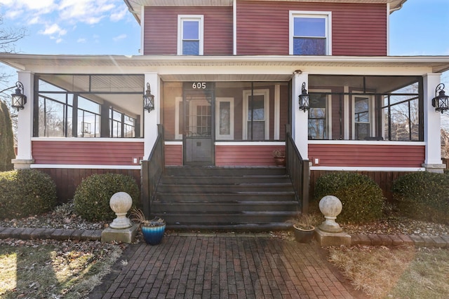 view of front of house with a sunroom