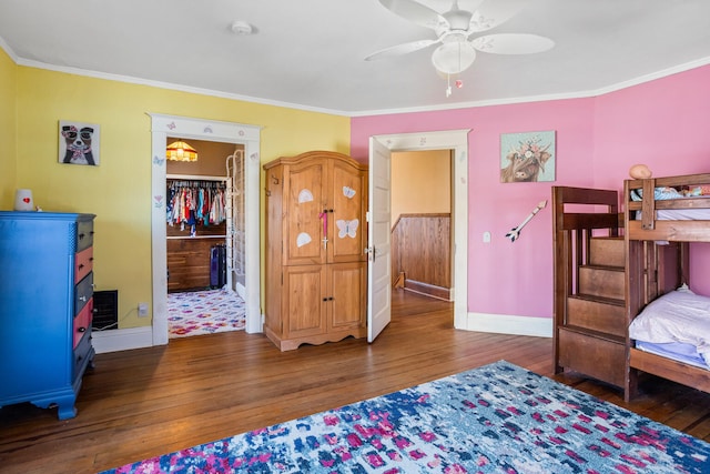 bedroom with baseboards, hardwood / wood-style floors, and crown molding