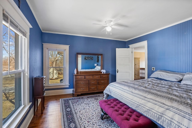 bedroom with ceiling fan, hardwood / wood-style floors, baseboards, and crown molding