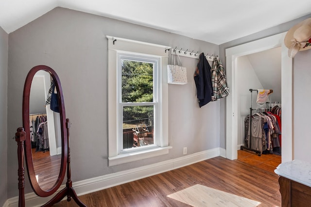 mudroom with baseboards, vaulted ceiling, and wood finished floors