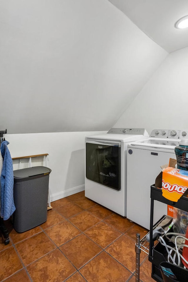 laundry area with laundry area, dark tile patterned floors, and washing machine and clothes dryer