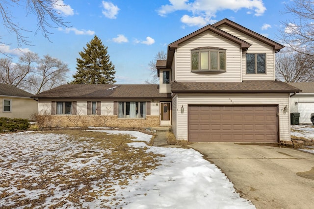 traditional home featuring concrete driveway, roof with shingles, and an attached garage