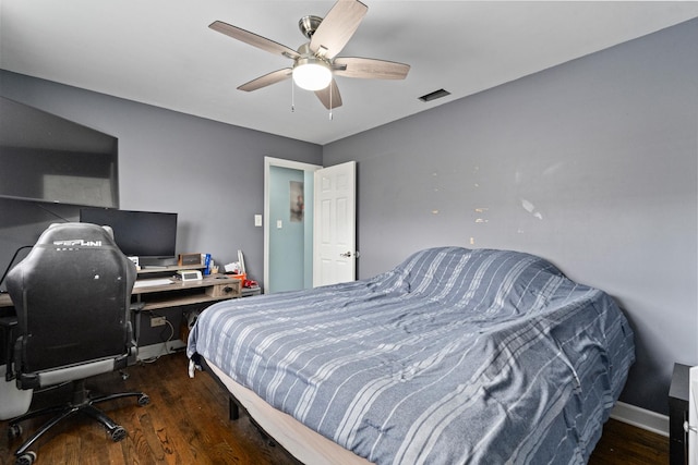 bedroom featuring ceiling fan, wood finished floors, visible vents, and baseboards