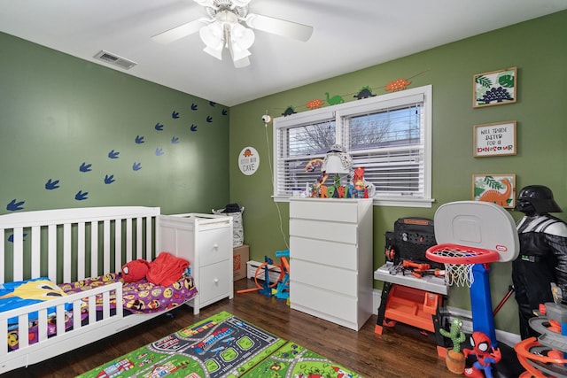 bedroom with a ceiling fan, visible vents, and wood finished floors