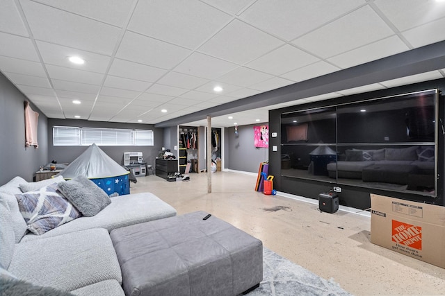 living area with baseboards, a paneled ceiling, and recessed lighting