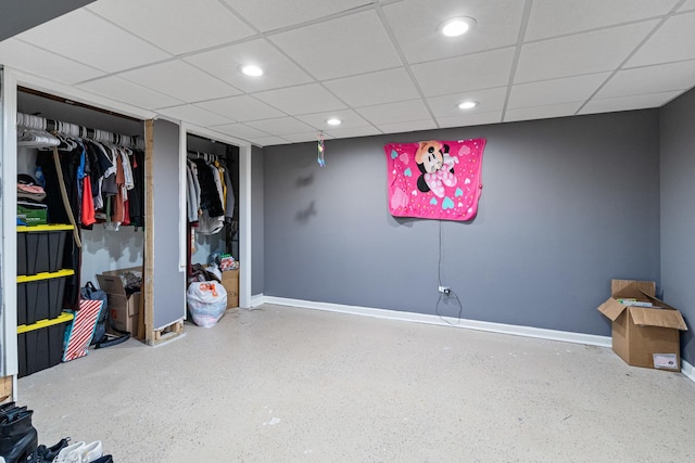 finished below grade area featuring recessed lighting, a drop ceiling, and baseboards
