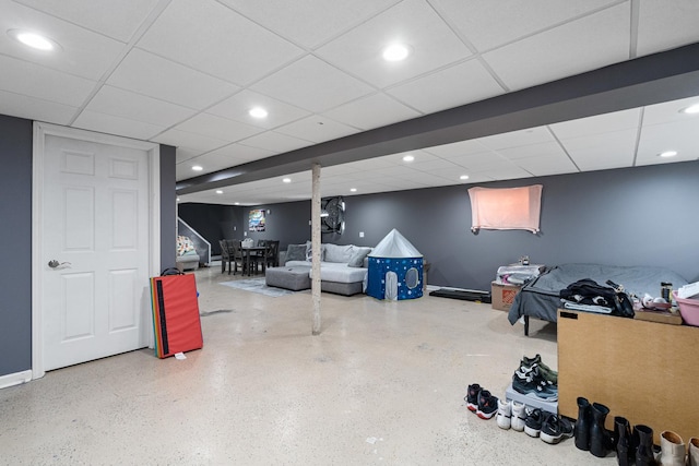 finished below grade area featuring baseboards, a drop ceiling, and recessed lighting
