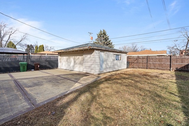 detached garage featuring fence