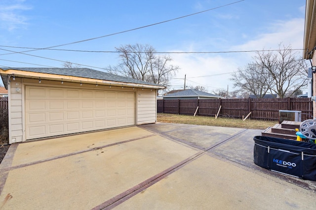 detached garage featuring fence