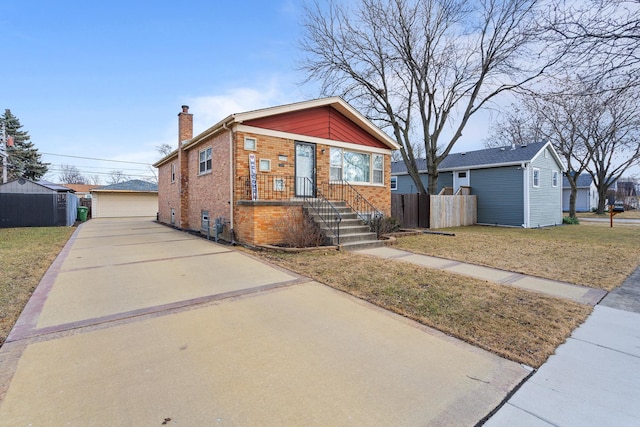 bungalow-style home with a chimney, an outbuilding, fence, a front lawn, and brick siding