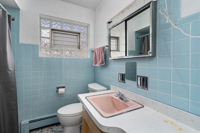 full bath featuring toilet, plenty of natural light, a baseboard heating unit, and tile walls