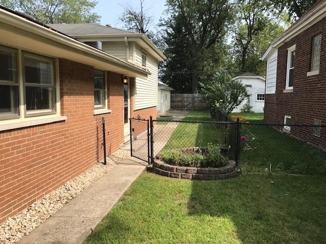 view of yard featuring fence and a gate