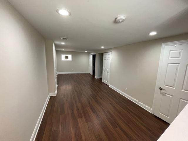 below grade area featuring recessed lighting, dark wood finished floors, and baseboards