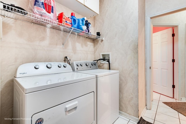 laundry room with light tile patterned floors, laundry area, and separate washer and dryer