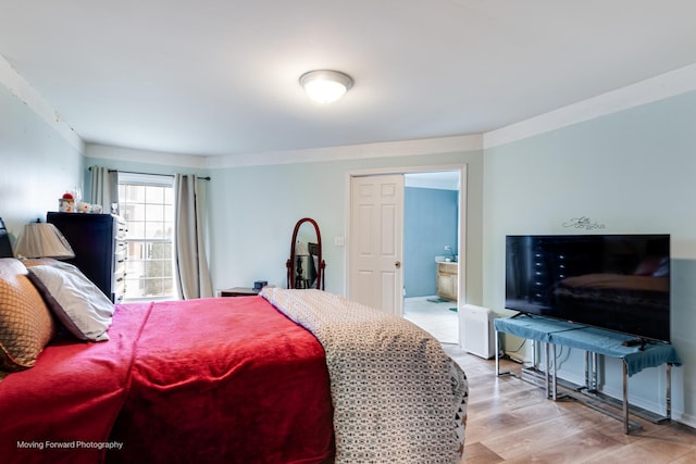 bedroom featuring light wood-style floors