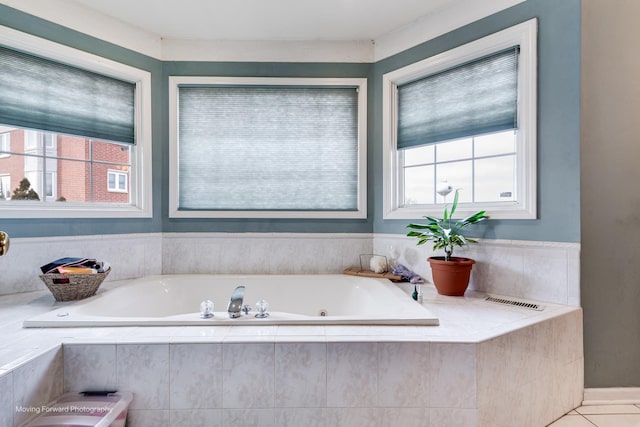 bathroom featuring a healthy amount of sunlight, a garden tub, and visible vents