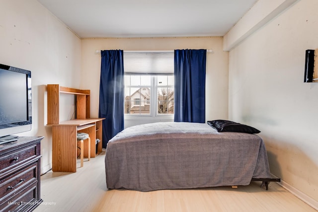 bedroom featuring baseboards and light wood-style floors