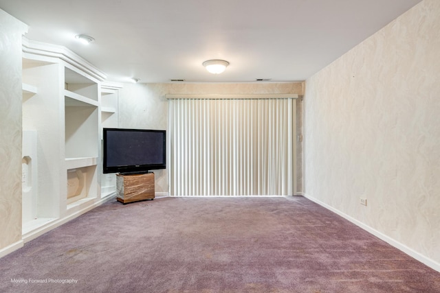 unfurnished living room featuring built in shelves, carpet floors, visible vents, a textured wall, and baseboards