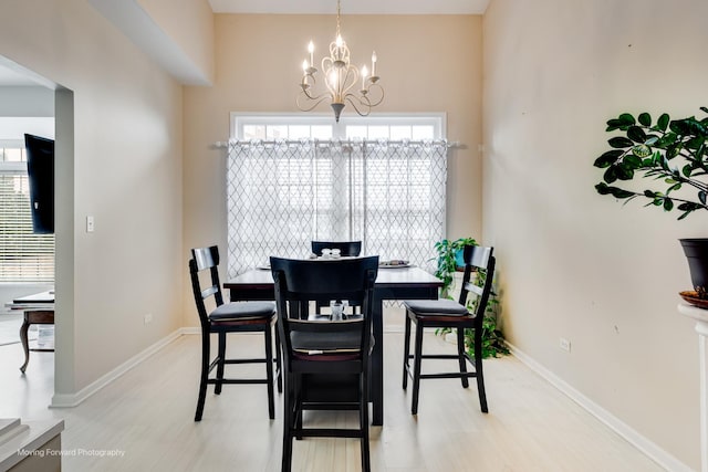 dining space with a chandelier and baseboards