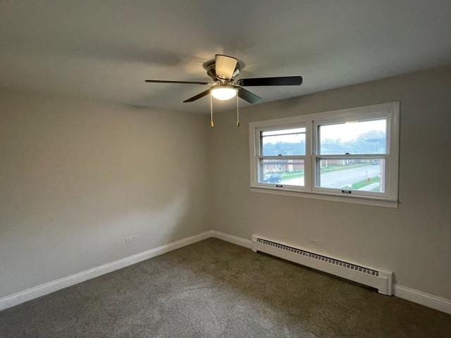 unfurnished room featuring baseboards, baseboard heating, a ceiling fan, and dark colored carpet