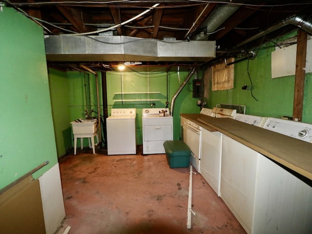 unfinished below grade area featuring separate washer and dryer and a sink