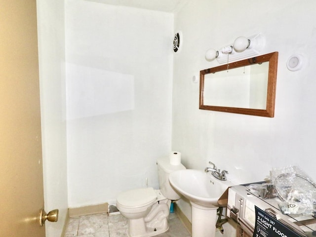 bathroom with toilet, baseboards, and tile patterned floors