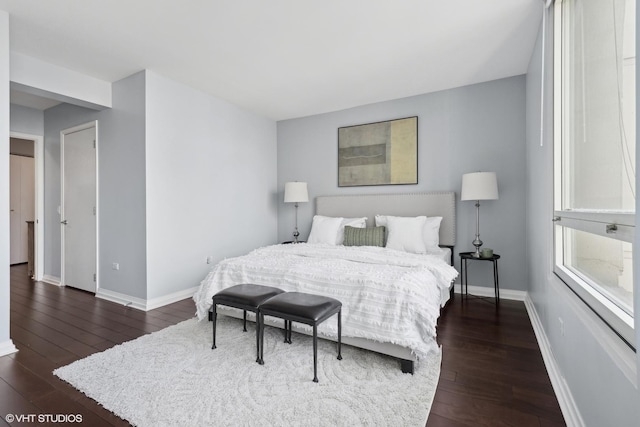 bedroom featuring dark wood-style floors and baseboards