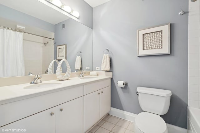 full bath with double vanity, tile patterned flooring, a sink, and toilet