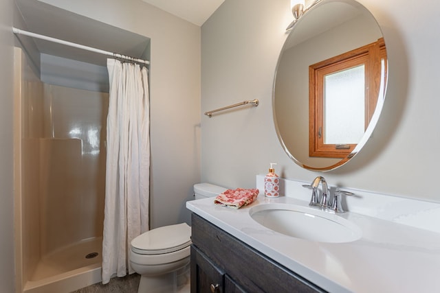 full bath with a stall shower, vanity, and toilet