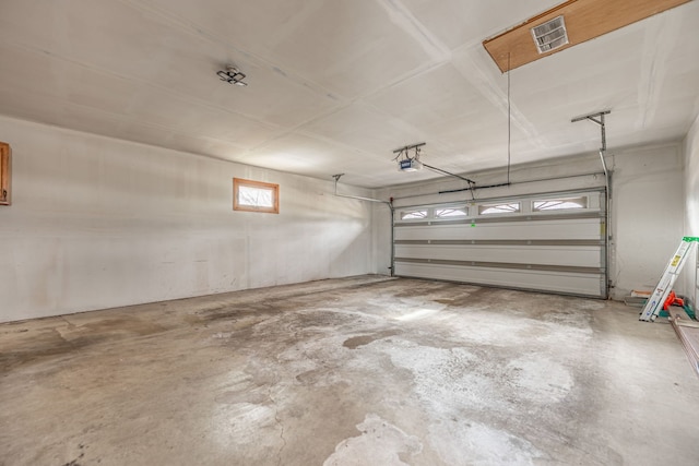 parking garage with visible vents and a garage door opener