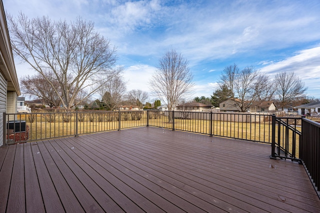 wooden terrace featuring a yard and a residential view