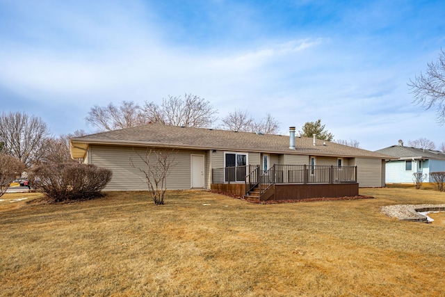 ranch-style home featuring an attached garage, a wooden deck, and a front lawn