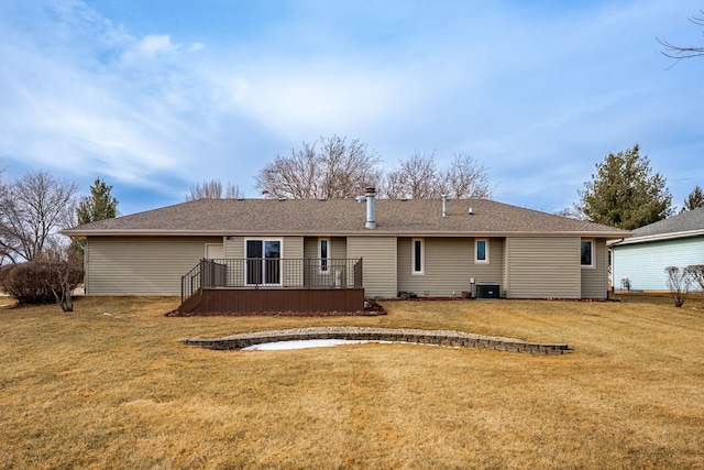 rear view of house with cooling unit, a lawn, and a deck