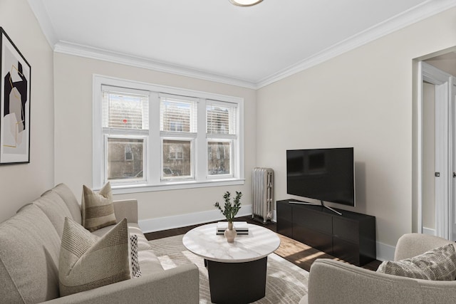 living area with radiator heating unit, baseboards, crown molding, and wood finished floors