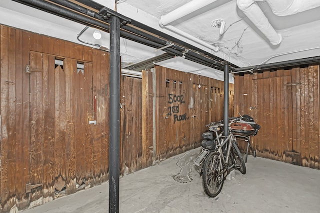 unfinished basement featuring wood walls