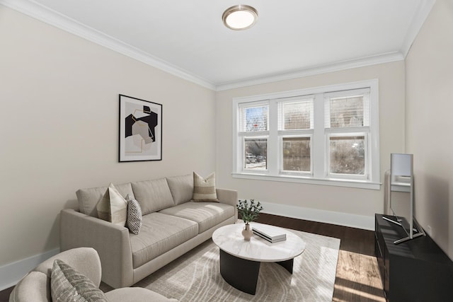 living room featuring ornamental molding, baseboards, and wood finished floors