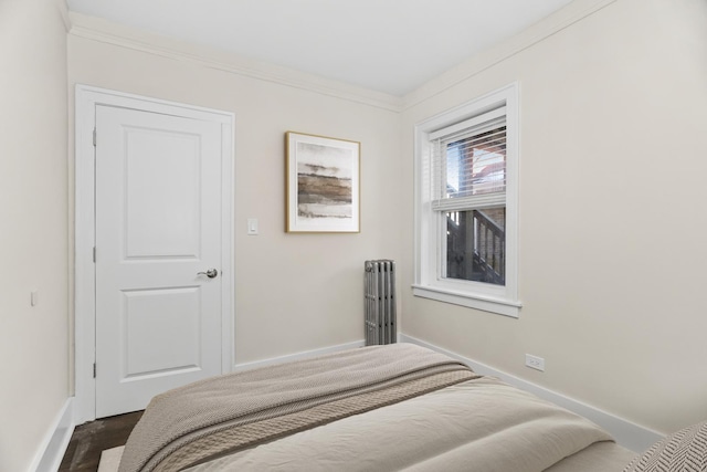 bedroom featuring ornamental molding and baseboards