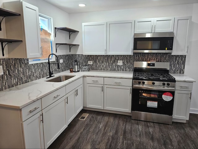 kitchen with white cabinetry, stainless steel appliances, and a sink