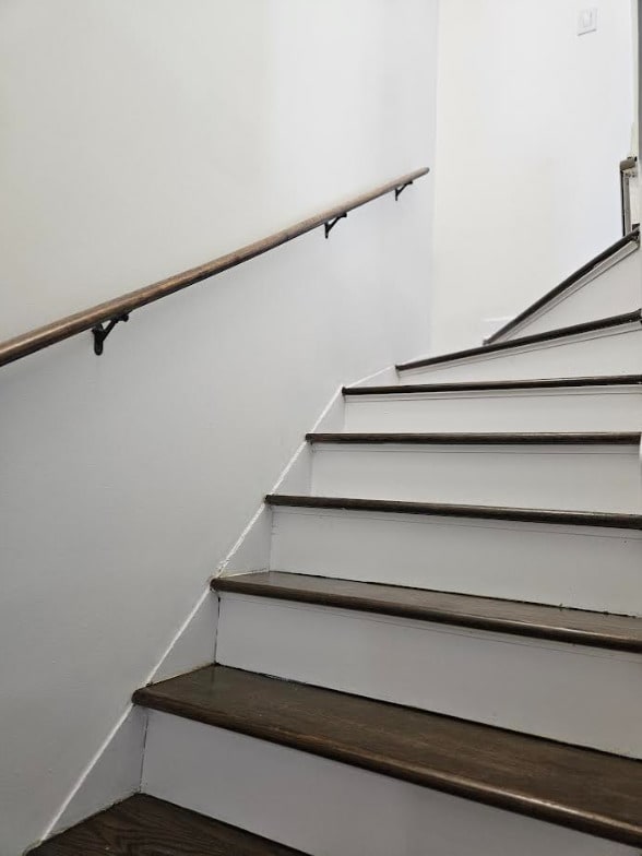 staircase with wood finished floors