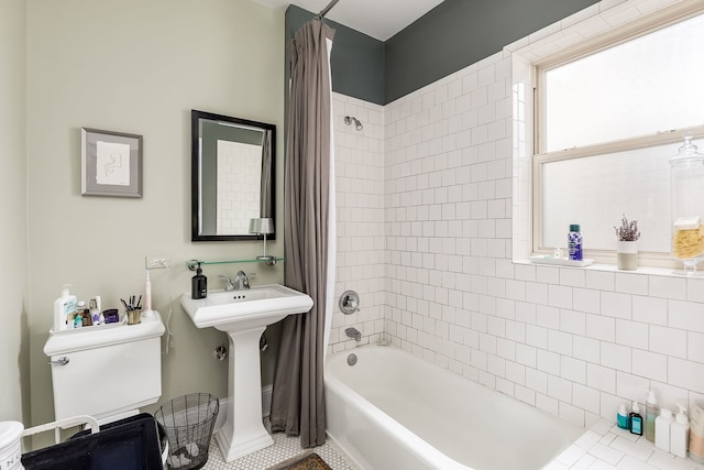 full bathroom with shower / bathtub combination with curtain and a sink