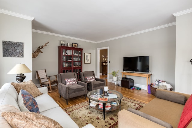 living room featuring ornamental molding and wood finished floors